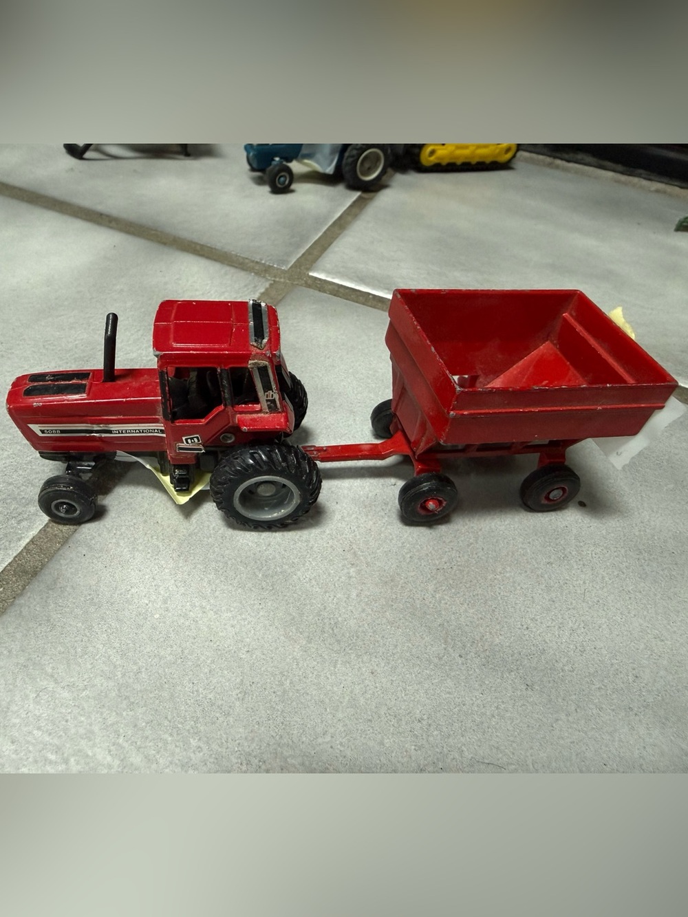 ERTL- Vintage 1/64 scale red harvester and matched grain wagon (set of 2 pieces)